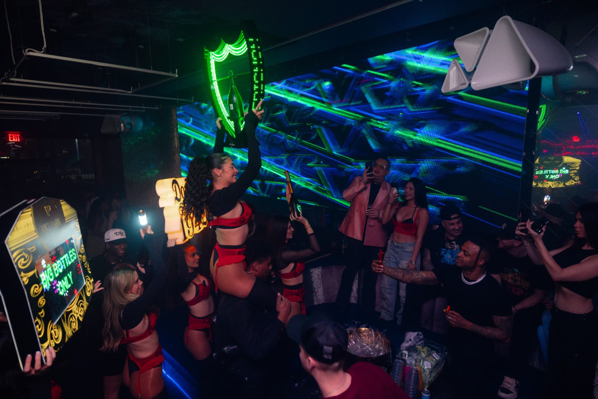 LED champagne-bottle presentation and laser wall inside Vice Park nightclub
